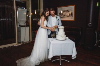 A couple cut their wedding cake during the reception