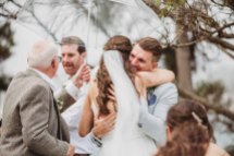 A bride hugs her groom as their wedding ceremony begins