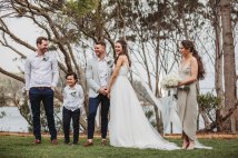 The bridal party smile at guests during the wedding ceremony