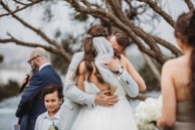 The bride & groom hug during their wedding ceremony